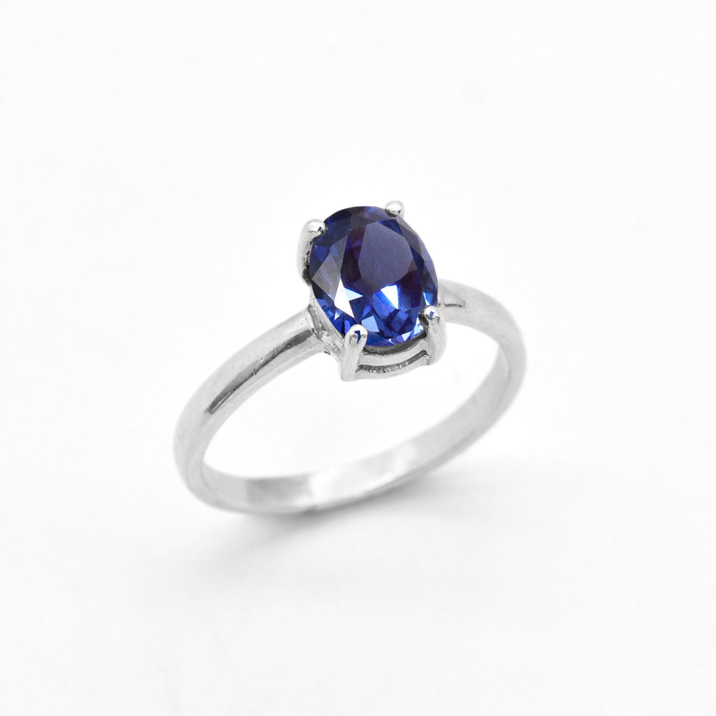 Tanzanite ring set in sterling silver showcasing deep blue diamond cut gemstone and smooth band
