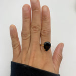 The teardrop Onyx Ring creates a refined silhouette for evening wear.