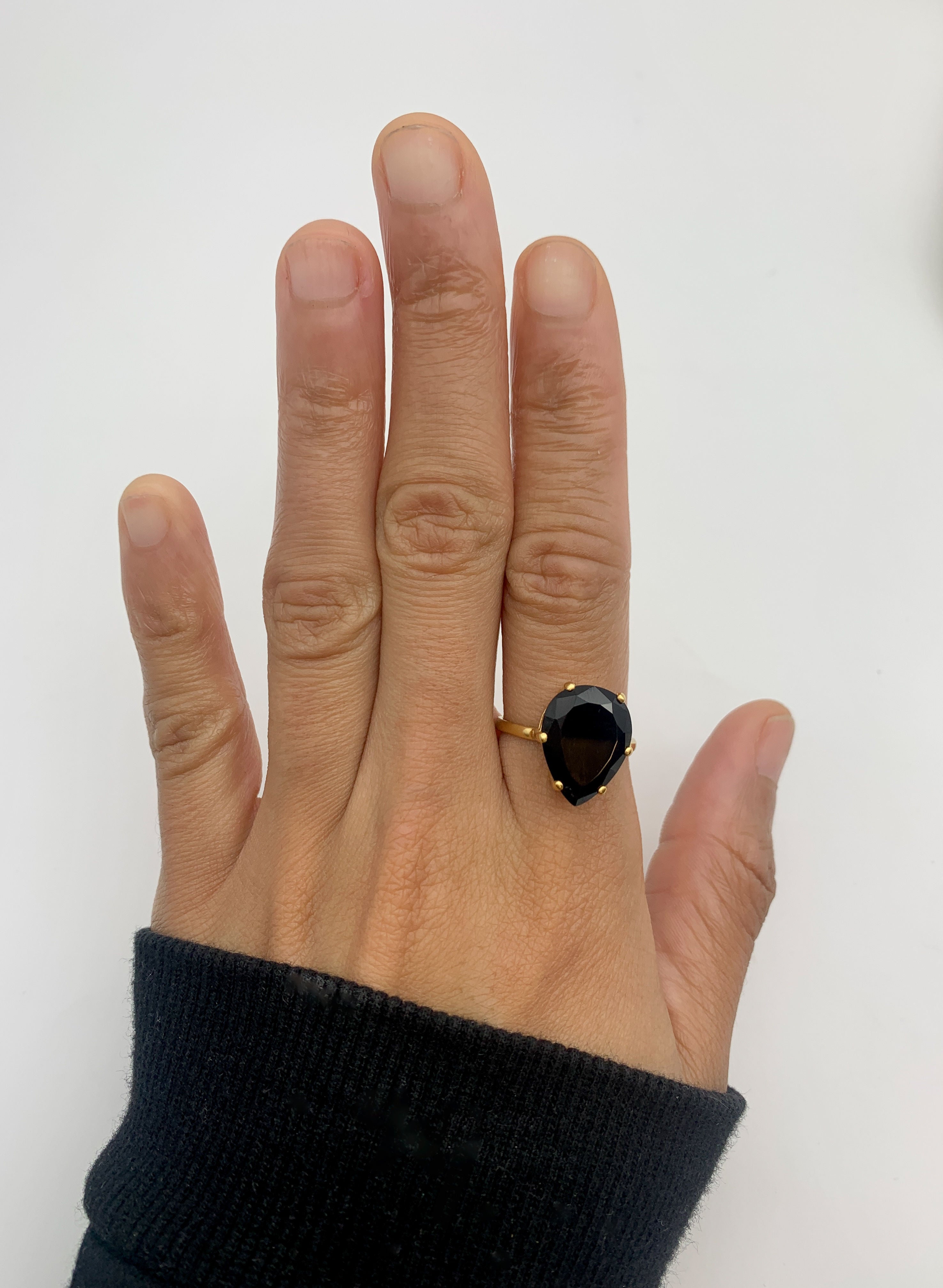 The teardrop Onyx Ring creates a refined silhouette for evening wear.