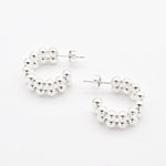 Top-down view of solid 925 sterling silver beaded hoop earrings with ball design
