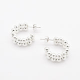 Top-down view of solid 925 sterling silver beaded hoop earrings with ball design
