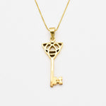18k yellow gold necklace with trinity knot design and long key pendant perfect as statement necklace