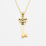 18k yellow gold necklace with trinity knot design and long key pendant perfect as statement necklace