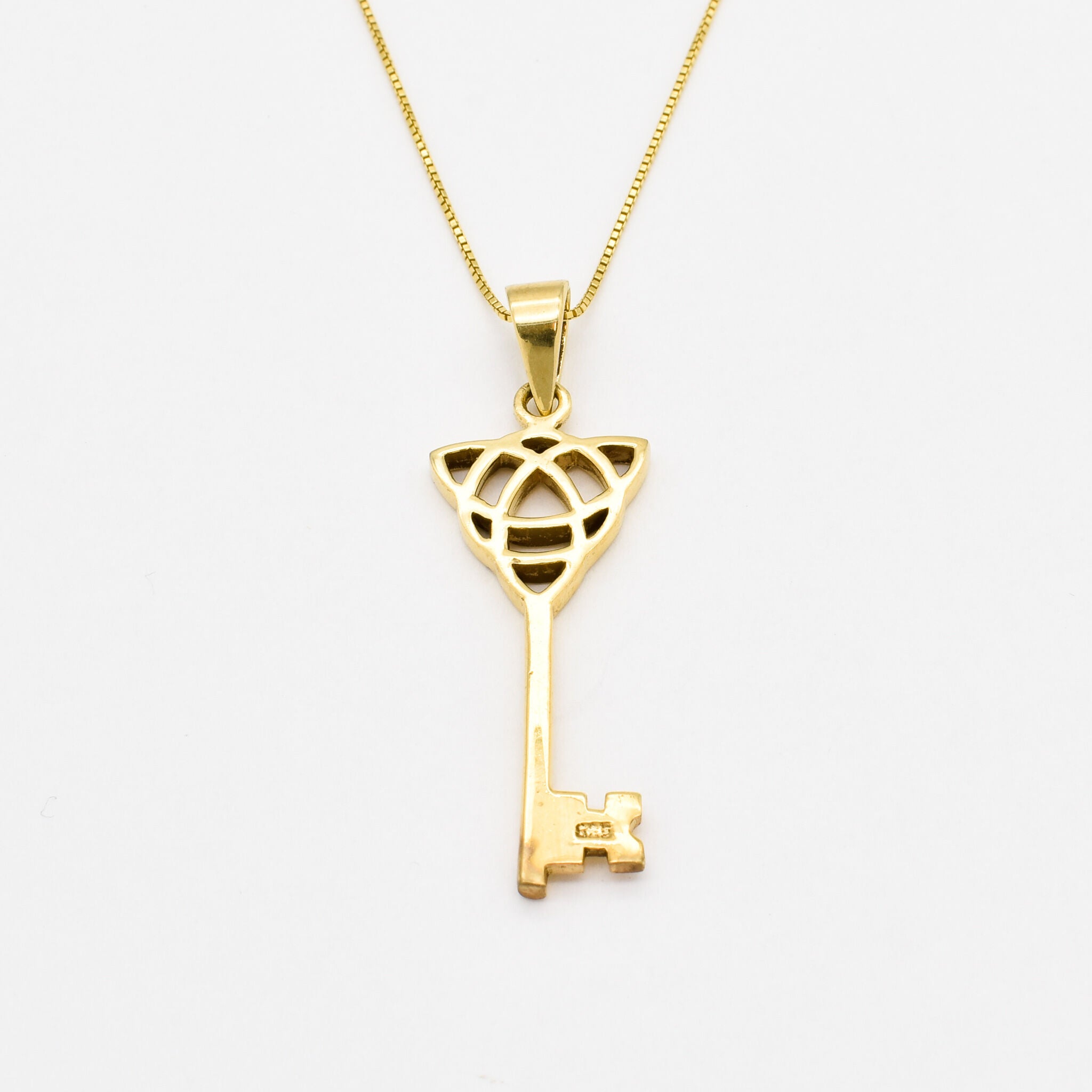 18k yellow gold necklace with trinity knot design and long key pendant perfect as statement necklace