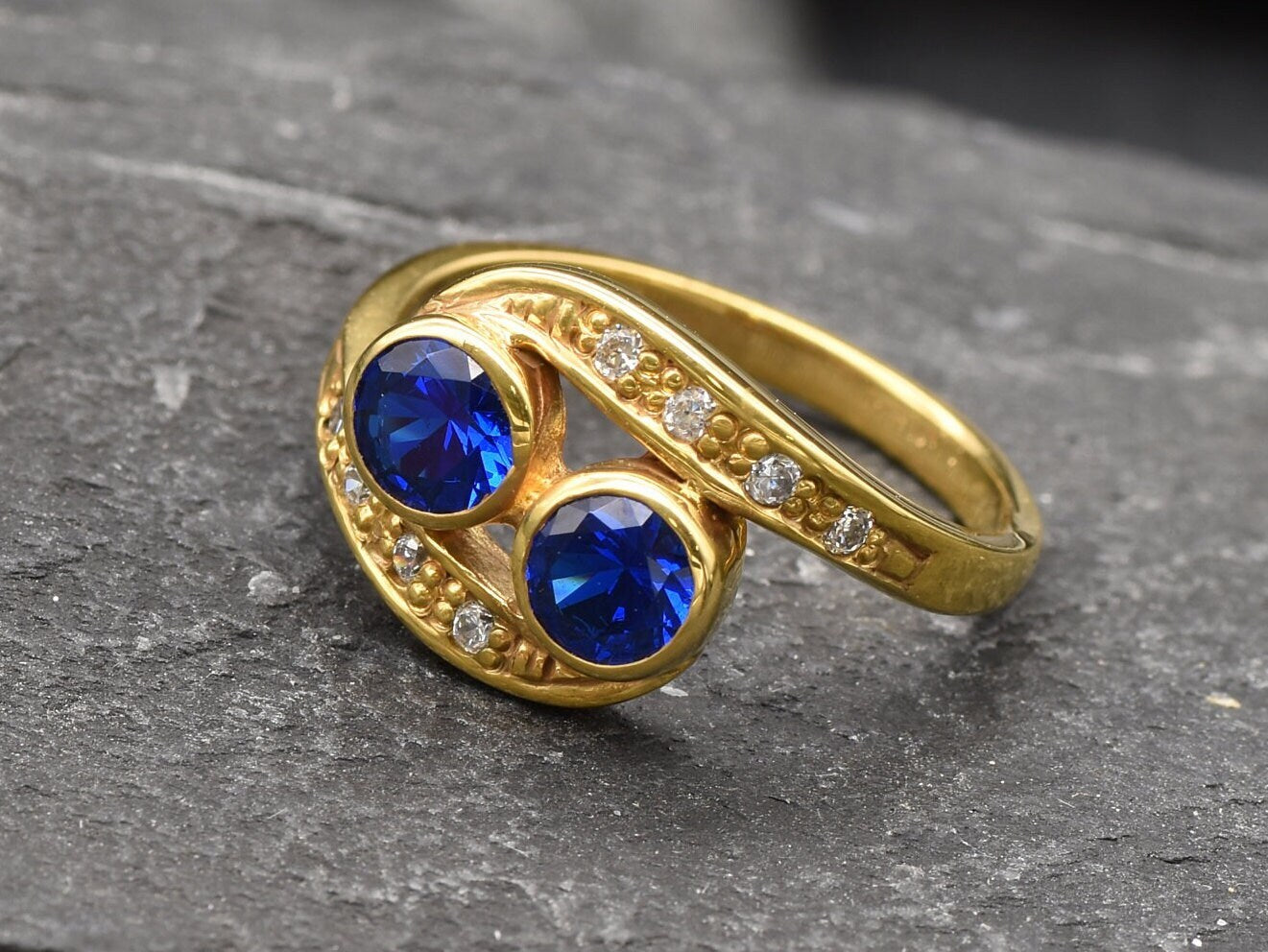 Elegant 18k Gold Vermeil two-stone sapphire ring, ideal for celebrating September birthdays and expressing love and loyalty.