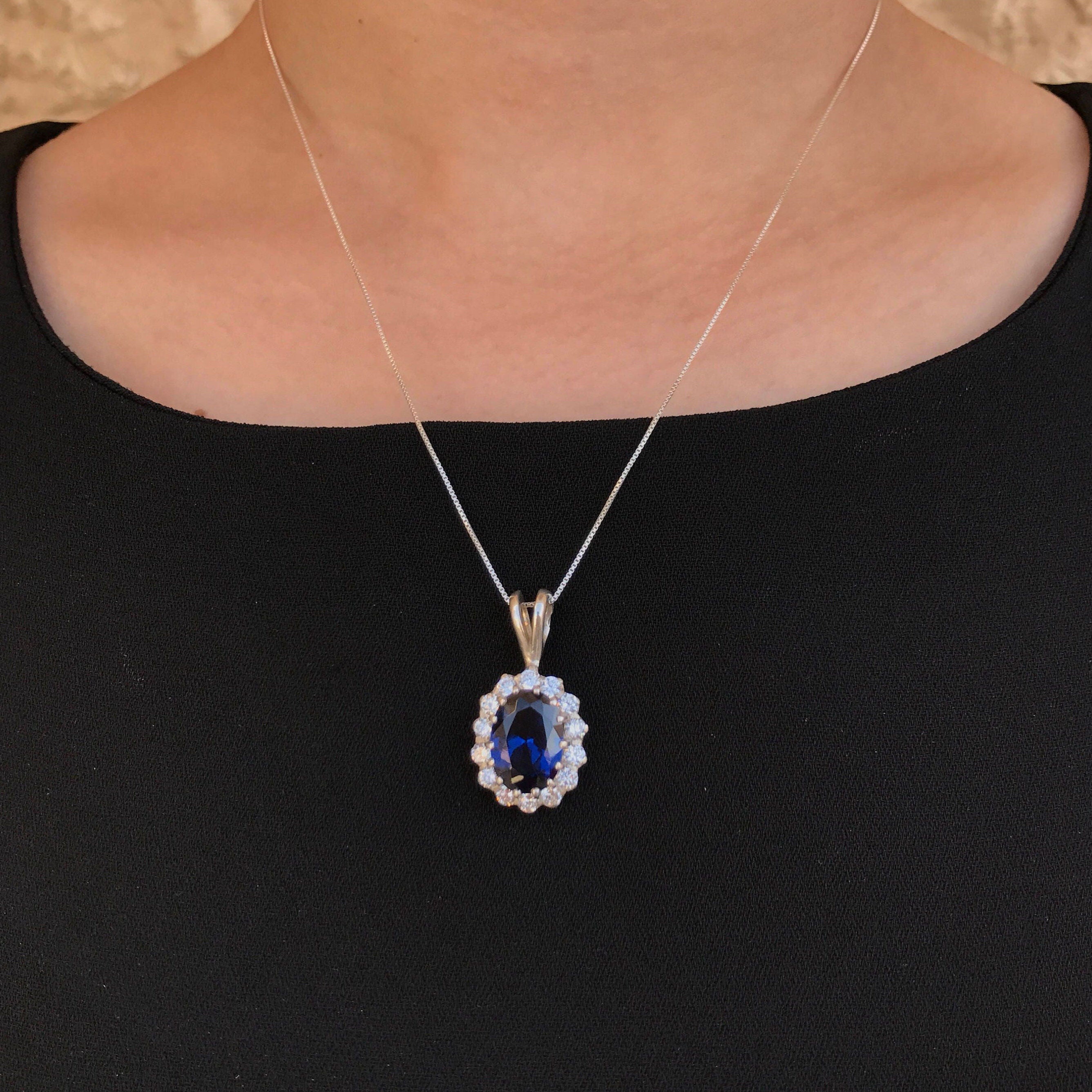 925 Sterling Silver Sapphire Pendant featuring a stunning oval blue sapphire in a halo setting, perfect for special occasions.
