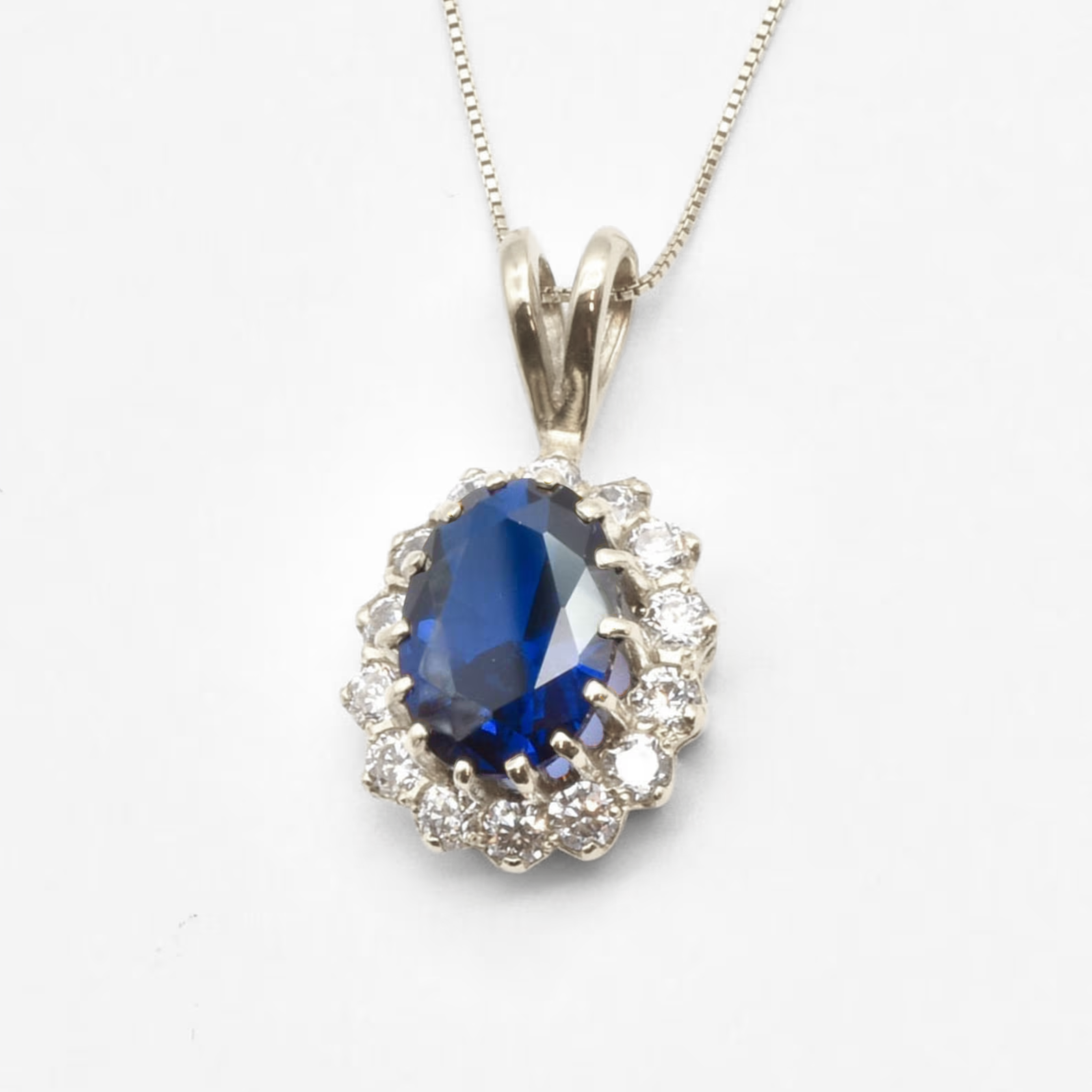 Created Sapphire Pendant made in 925 Sterling Silver with Oval Created Blue Sapphire in Halo setting, September Birthstone gift idea, symbolizes sincerity, truth, and faithfulness, ideal for everyday wear and perfect for birthday gifting and special occasions.