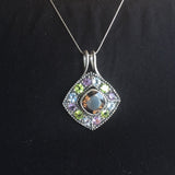 Smoky Topaz statement pendant worn over a black crew neck top—adds vivid contrast and bold sparkle, perfect for elegant casual days