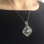 Smoky Topaz statement pendant worn over a black crew neck top—adds vivid contrast and bold sparkle, perfect for elegant casual days